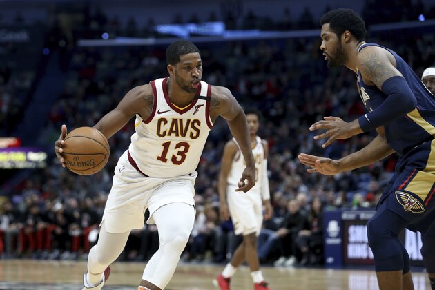 Cleveland Cavaliers center Tristan Thompson (13) dribbles past New Orleans Pelicans center Derrick Favors during the first half of an NBA basketball game in New Orleans, Friday, Feb. 28, 2020. (AP Photo/Rusty Costanza)