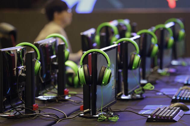 In this Thursday, Aug. 29, 2019 photo, headphones are placed on top of computer screens as it awaits esport (electronic sport) players who will participate in the qualifying rounds for the first Philippine esport team in metropolitan Manila, Philippines. Esports, a form of competition using video games, will be making its debut as a medal sport at the 30th South East Asian Games in the country which starts November this year. (AP Photo/Aaron Favila)