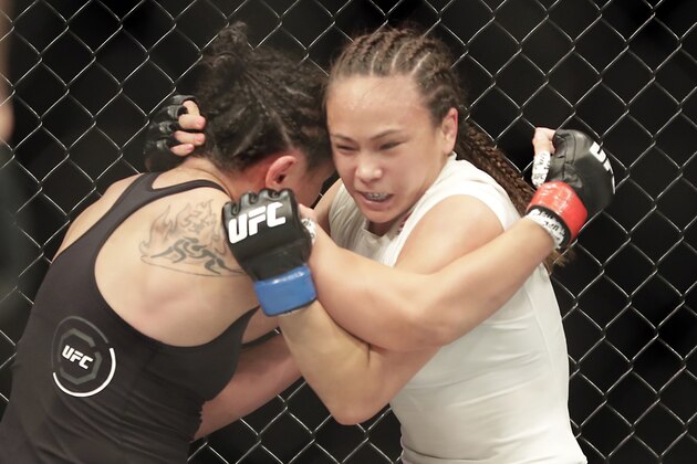 Carla Esparza, left, fights with Michelle Waterson during a UFC 249 mixed martial arts bout Saturday, May 9, 2020, in Jacksonville, Fla. (AP Photo/John Raoux)