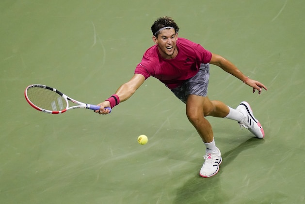 Dominic Thiem, of Austria, returns a shot to Daniil Medvedev, of Russia, during a men's semifinal match of the US Open tennis championships, Friday, Sept. 11, 2020, in New York. (AP Photo/Seth Wenig)