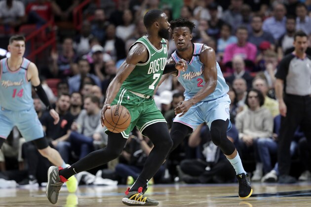 Boston Celtics guard Jaylen Brown (7) drives to the basket as Miami Heat forward Jimmy Butler (22) defends during the first half of an NBA basketball game, Tuesday, Jan. 28, 2020, in Miami. (AP Photo/Lynne Sladky)