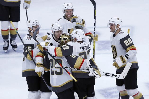 The Vegas Golden Knights celebrate Shea Theodore's shootout goal against the Chicago Blackhawks in an NHL hockey game Tuesday, Oct. 22, 2019, in Chicago. The Golden Knights won 2-1. (AP Photo/Charles Rex Arbogast)