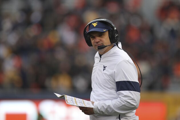 FILE - In this Nov. 23, 2019, file photo, West Virginia head coach Neal Brown watches during the second quarter of an NCAA college football game against Oklahoma State, in Morgantown, W.Va. .Brown went 5-7 in his first season at West Virginia in 2019 and faces challenges on both sides of the ball as the Mountaineers try to compete for a Big 12 title. (AP Photo/Chris Jackson, File)