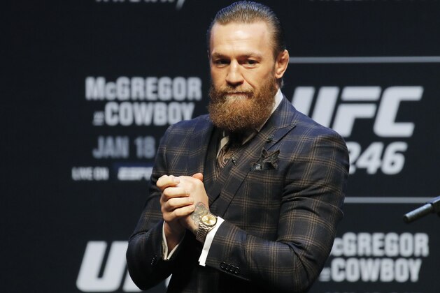 Conor McGregor motions to the crowd during a news conference for a UFC 246 mixed martial arts bout, Wednesday, Jan. 15, 2020, in Las Vegas. McGregor is scheduled to fight Donald