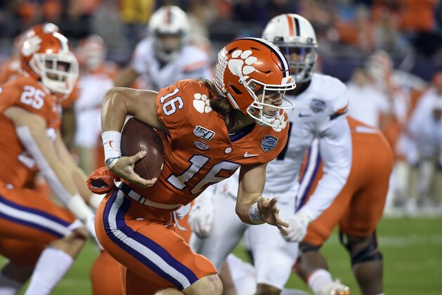 Clemson quarterback Trevor Lawrence (16) runs against Virginia during the first half of the Atlantic Coast Conference championship NCAA college football game in Charlotte, N.C., Saturday, Dec. 7, 2019. (AP Photo/Mike McCarn)