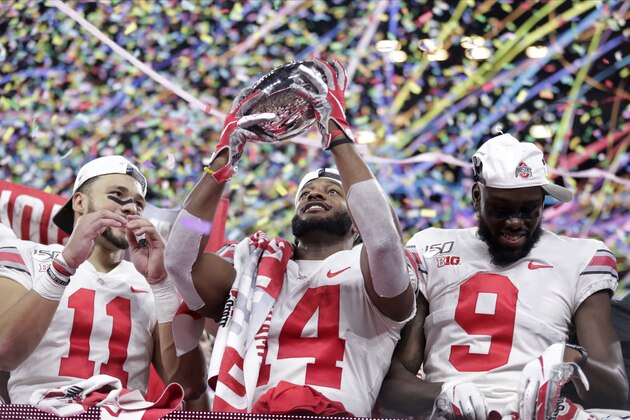Ohio State wide receiver K.J. Hill (14) holds the trophy following the team's 34=21 win over Wisconsin in the Big Ten championship NCAA college football game, early Sunday, Dec. 8, 2019, in Indianapolis. (AP Photo/Michael Conroy)