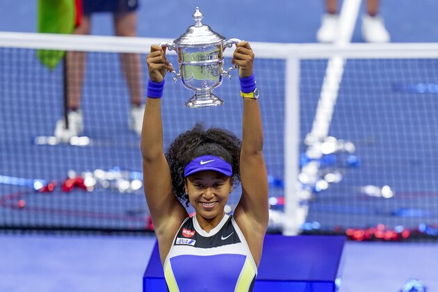 Naomi Osaka, of Japan, holds up the championship trophy after defeating Victoria Azarenka, of Belarus, in the women's singles final of the US Open tennis championships, Saturday, Sept. 12, 2020, in New York. (AP Photo/Frank Franklin II)
