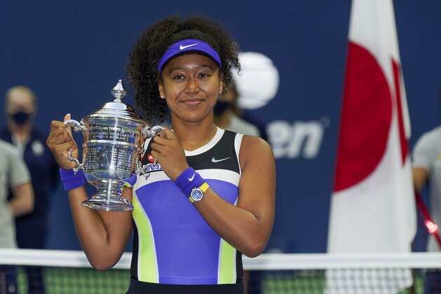 Naomi Osaka, of Japan, holds up the championship trophy after defeating Victoria Azarenka, of Belarus, in the women's singles final of the US Open tennis championships, Saturday, Sept. 12, 2020, in New York. (AP Photo/Seth Wenig) Naomi Osaka, of Japan, holds up the championship trophy after defeating Victoria Azarenka, of Belarus, in the women's singles final of the US Open tennis championships, Saturday, Sept. 12, 2020, in New York. (AP Photo/Seth Wenig)