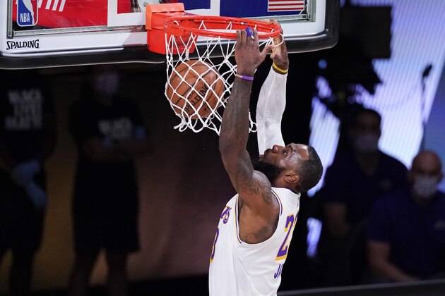 Los Angeles Lakers' LeBron James dunks against the Houston Rockets during the first half of an NBA conference semifinal playoff basketball game Saturday, Sept. 12, 2020, in Lake Buena Vista, Fla. (AP Photo/Mark J. Terrill)