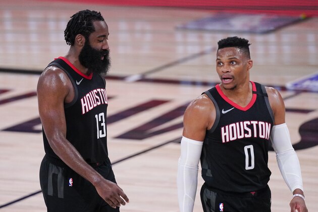 Houston Rockets' James Harden, left and Russell Westbrook walks together during the second half of an NBA conference semifinal playoff basketball game against the Los Angeles Lakers Saturday, Sept. 12, 2020, in Lake Buena Vista, Fla. (AP Photo/Mark J. Terrill)