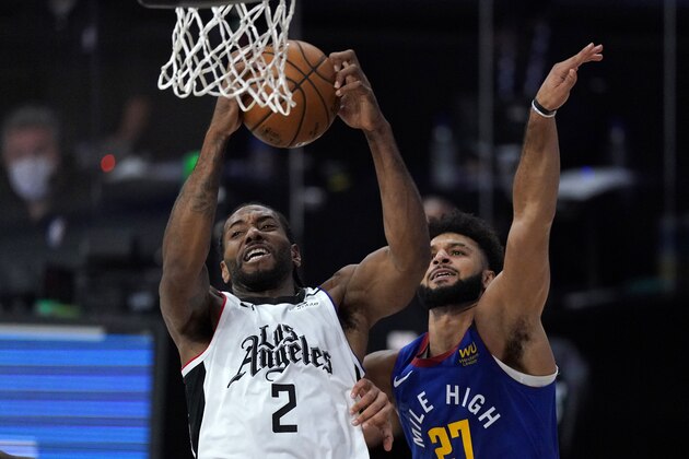 Los Angeles Clippers' Kawhi Leonard (2) pulls in a rebound against Denver Nuggets' Jamal Murray (27) during the first half of an NBA conference semifinal playoff basketball game, Friday, Sept. 11, 2020, in Lake Buena Vista, Fla. (AP Photo/Mark J. Terrill)