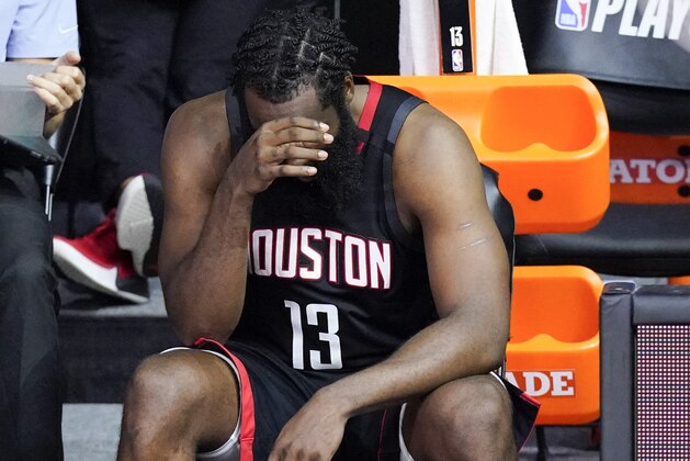 Houston Rockets' James Harden cover his face in the closing minutes of a loss to the Los Angeles Lakers during the second half of an NBA conference semifinal playoff basketball game Saturday, Sept. 12, 2020, in Lake Buena Vista, Fla. (AP Photo/Mark J. Terrill)