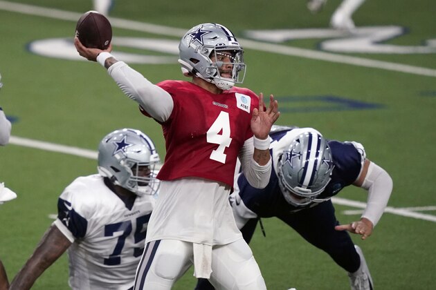 Dallas Cowboys quarterback Dak Prescott (4) passes against defender DeMarcus Lawrence (90) during an NFL football training camp practice in Frisco, Texas, Monday, Aug. 31, 2020. (AP Photo/LM Otero)