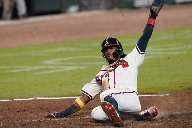 Atlanta Braves' Ronald Acuna Jr. scores during the fourth inning of the team's baseball game against the Miami Marlins on Wednesday, Sept. 9, 2020, in Atlanta. (AP Photo/Brynn Anderson)