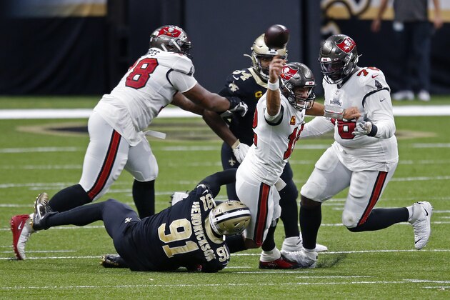 Tampa Bay Buccaneers quarterback Tom Brady (12) tries to throw as he is brought down by New Orleans Saints defensive end Trey Hendrickson (91) in the first half of an NFL football game in New Orleans, Sunday, Sept. 13, 2020. He was called for intentional grounding on the play. (AP Photo/Butch Dill) Tampa Bay Buccaneers quarterback Tom Brady (12) tries to throw as he is brought down by New Orleans Saints defensive end Trey Hendrickson (91) in the first half of an NFL football game in New Orleans, Sunday, Sept. 13, 2020. He was called for intentional grounding on the play. (AP Photo/Butch Dill)