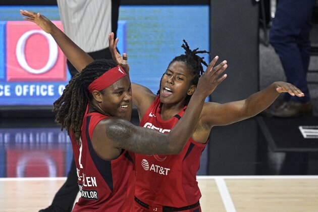 Washington Mystics forward Myisha Hines-Allen (2) is congratulated by guard Ariel Atkins after Hines-Allen made a 3-point basket as time expired in the first half of the team's WNBA basketball game against the Los Angeles Sparks, Thursday, Sept. 10, 2020, in Bradenton, Fla. (AP Photo/Phelan M. Ebenhack)