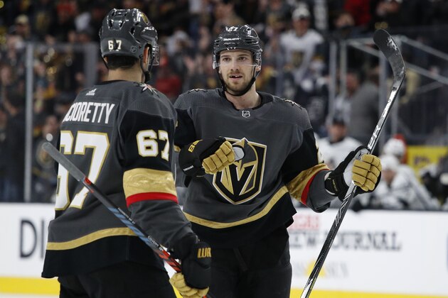 Vegas Golden Knights defenseman Shea Theodore, right, celebrates after scoring against the Los Angeles Kings during the second period of an NHL hockey game Sunday, March 1, 2020, in Las Vegas. (AP Photo/John Locher)