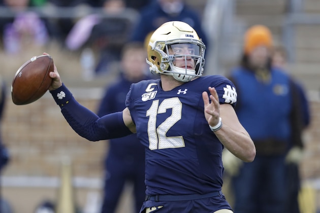 Notre Dame quarterback Ian Book (12) throws against Boston College during the first half of an NCAA college football game in South Bend, Ind., Saturday, Nov. 23, 2019. (AP Photo/Michael Conroy)