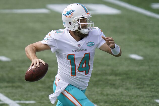 FILE - Miami Dolphins quarterback Ryan Fitzpatrick scrambles to pass against the New England Patriots in the second half of an NFL football game, Monday, Sept. 14, 2020, in Foxborough, Mass. The Miami Dolphins’ self-professed placeholder at quarterback played like one in the season opener, amplifying questions about the team’s timetable for turning to rookie Tua Tagovailoa. (AP Photo/Steven Senne, File) FILE - Miami Dolphins quarterback Ryan Fitzpatrick scrambles to pass against the New England Patriots in the second half of an NFL football game, Monday, Sept. 14, 2020, in Foxborough, Mass. The Miami Dolphins’ self-professed placeholder at quarterback played like one in the season opener, amplifying questions about the team’s timetable for turning to rookie Tua Tagovailoa. (AP Photo/Steven Senne, File)