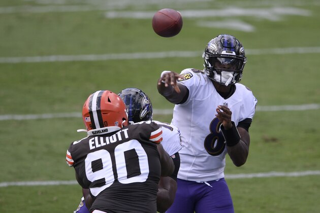 Baltimore Ravens quarterback Lamar Jackson (8) passes the ball during an NFL football game against Cleveland Browns defensive tackle Jordan Elliott (90), Sunday, Sept. 13, 2020, in Baltimore. (AP Photo/Nick Wass)