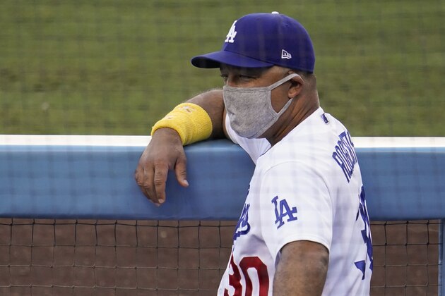 Los Angeles Dodgers manager Dave Roberts stands in the dugout before a baseball game against the Colorado Rockies Saturday, Sept. 5, 2020, in Los Angeles. (AP Photo/Marcio Jose Sanchez)