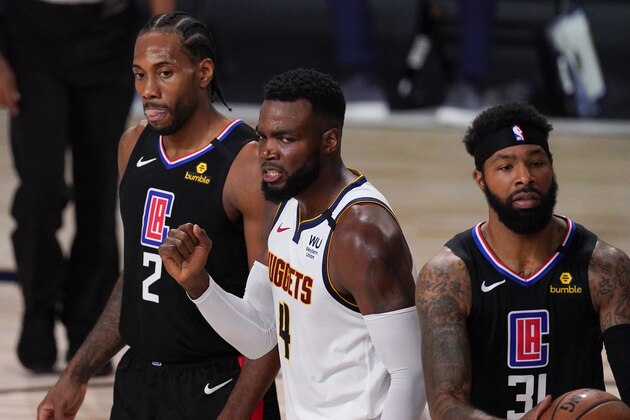 Denver Nuggets' Paul Millsap (4) reacts between Los Angeles Clippers' Kawhi Leonard (2) and Marcus Morris Sr., right, during the first half of an NBA conference semifinal playoff basketball game Saturday, Sept. 5, 2020, in Lake Buena Vista, Fla. (AP Photo/Mark J. Terrill)