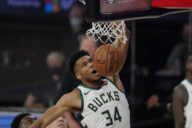 Milwaukee Bucks' Giannis Antetokounmpo (34) dunks in the second half of an NBA conference semifinal playoff basketball game against the Miami Heat Friday, Sept. 4, 2020, in Lake Buena Vista, Fla. (AP Photo/Mark J. Terrill)