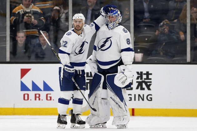 Tampa Bay Lightning's Kevin Shattenkirk (22) congratulates goaltender Andrei Vasilevskiy after the team's 5-3 win over the Boston Bruins in an NHL hockey game Saturday, March 7, 2020, in Boston. (AP Photo/Winslow Townson)