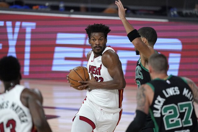 Miami Heat's Jimmy Butler, center, handles the ball as Boston Celtics' Jayson Tatum, rear, and Daniel Theis (27) defend during the first half of an NBA conference final playoff basketball game, Tuesday, Sept. 15, 2020, in Lake Buena Vista, Fla. (AP Photo/Mark J. Terrill) Miami Heat's Jimmy Butler, center, handles the ball as Boston Celtics' Jayson Tatum, rear, and Daniel Theis (27) defend during the first half of an NBA conference final playoff basketball game, Tuesday, Sept. 15, 2020, in Lake Buena Vista, Fla. (AP Photo/Mark J. Terrill)
