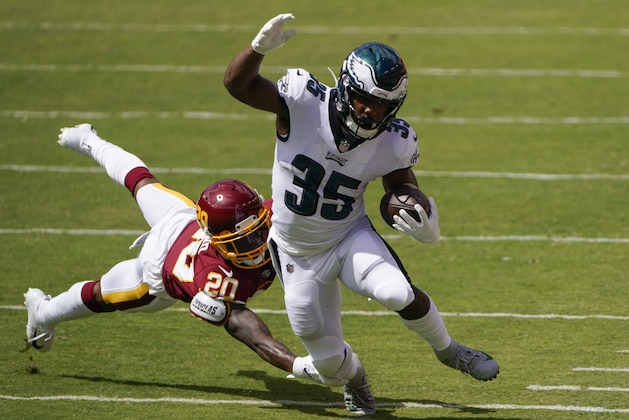 Philadelphia Eagles running back Boston Scott (35) breaks away from a tackle from Washington Football Team cornerback Jimmy Moreland (20) during the first half of an NFL football game, Sunday, Sept. 13, 2020, in Landover, Md. (AP Photo/Susan Walsh)