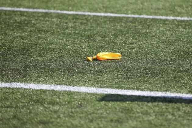 A penalty flag sits on the turf during the second half of an NFL football game between the Miami Dolphins and New England Patriots, Sunday, Sept. 13, 2020, in Foxborough, Mass. (AP Photo/Stew Milne)