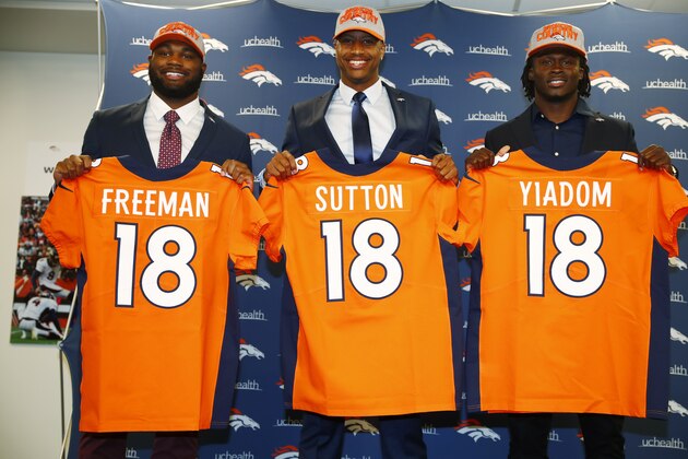 From left, Denver Broncos second and third-round picks in the NFL Draft, Royce Freeman, Cortland Sutton and Isaac Yiadom, hold up jerseys during a photo opportunity after they were introduced to the media Saturday, April 28, 2018, in Englewood, Colo. Sutton was the team's second-round pick. Freeman and Yiadom were both third-round picks for the Broncos. (AP Photo/David Zalubowski)