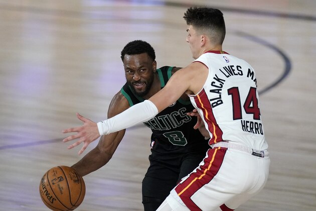 Boston Celtics' Kemba Walker (8) looks to make a pass as Miami Heat's Tyler Herro (14) defends during the second half of an NBA conference final playoff basketball game, Tuesday, Sept. 15, 2020, in Lake Buena Vista, Fla. (AP Photo/Mark J. Terrill)