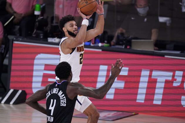 Denver Nuggets guard Jamal Murray (27) shoots past LA Clippers forward JaMychal Green (4) during the first half of an NBA conference semifinal playoff basketball game Tuesday, Sept. 15, 2020, in Lake Buena Vista, Fla. (AP Photo/Mark J. Terrill)