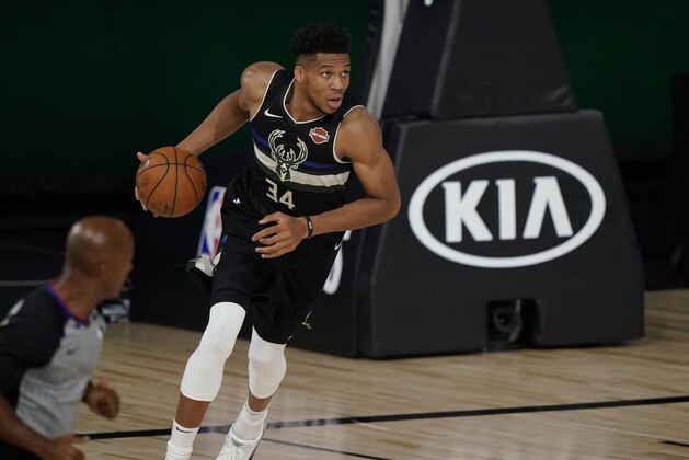 Milwaukee Bucks' Giannis Antetokounmpo (34) dribbles against the Miami Heat during the second half of an NBA conference semifinal playoff basketball game Wednesday, Sept. 2, 2020, in Lake Buena Vista, Fla. (AP Photo/Mark J. Terrill)