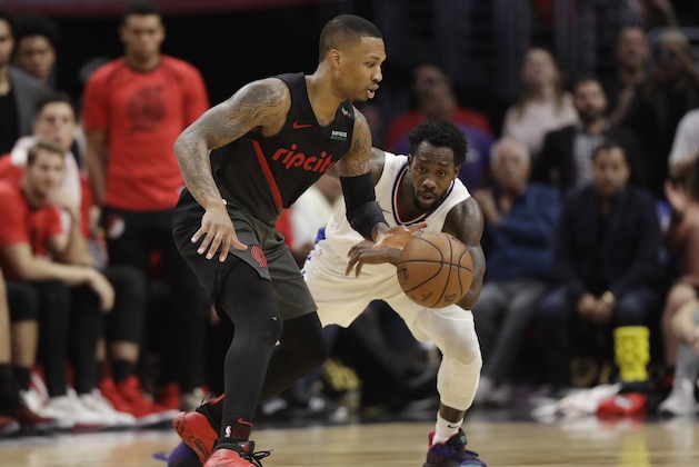 Portland Trail Blazers' Damian Lillard, left, is defended by Los Angeles Clippers' Patrick Beverley during the second half of an NBA basketball game Monday, Dec. 17, 2018, in Los Angeles. (AP Photo/Marcio Jose Sanchez)