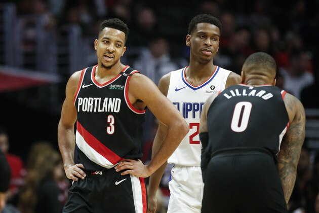 Portland Trail Blazers' CJ McCollum (3) talks to his teammate Damian Lillard (0) during an NBA basketball game between Los Angeles Clippers and Portland Trail Blazers, Tuesday, March 12, 2019, in Los Angeles. (AP Photo/Ringo H.W. Chiu)