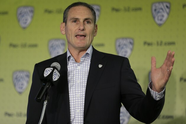 FILE - In this Oct. 12, 2017, file photo, Pac-12 commissioner Larry Scott gestures while speaking a NCAA college basketball Pac-12 media day, in San Francisco. A Pac-12 task force on reforming college basketball is recommending an end to the NBA’s one-and-done rule, allowing players to return to school even after they are drafted, and that the NCAA facilitate access to agents for high school players. The Pac-12 announced the recommendations from its task force on Tuesday, March 13, 2018, and its report has been sent to the NCAA’s commission on college basketball, headed by former Secretary of State and Stanford University Provost Condoleezza Rice. (AP Photo/Eric Risberg, File)