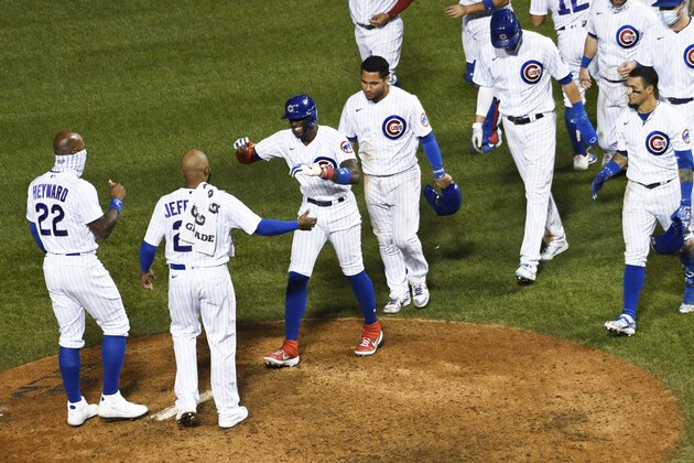 Chicago Cubs' Cameron Maybin, third from left, smiles after walking with the bases loaded to drive in the winning run against the Cleveland Indians in a baseball game Tuesday, Sept. 15, 2020, in Chicago. (AP Photo/David Banks) Chicago Cubs' Cameron Maybin, third from left, smiles after walking with the bases loaded to drive in the winning run against the Cleveland Indians in a baseball game Tuesday, Sept. 15, 2020, in Chicago. (AP Photo/David Banks)