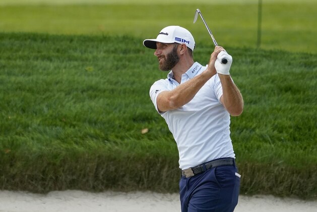 Dustin Johnson, of the United States, hits out of a bunker during a practice round for the US Open Golf Championship, Wednesday, Sept. 16, 2020, in New York. (AP Photo/Charles Krupa)
