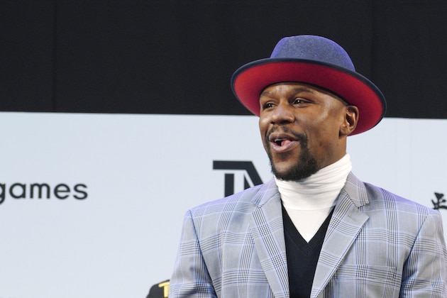 Floyd Mayweather Jr. smiles at the stage as he meets Japanese kickboxer Tenshin Nasukawa, during a ceremony at Saitama Super Arena in Saitama, north of Tokyo Sunday, Dec. 30, 2018. Mayweather is scheduled to fight in a three-round exhibition match in Japan on New Year's Eve. (AP Photo/Eugene Hoshiko)