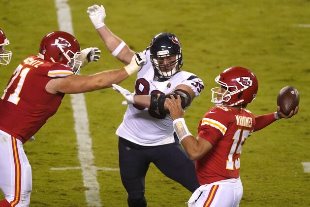 Kansas City Chiefs quarterback Patrick Mahomes (15) passes as he is pressured by Houston Texans defensive end J.J. Watt (99) in the first half of an NFL football game Thursday, Sept. 10, 2020, in Kansas City, Mo. (AP Photo/Charlie Riedel)