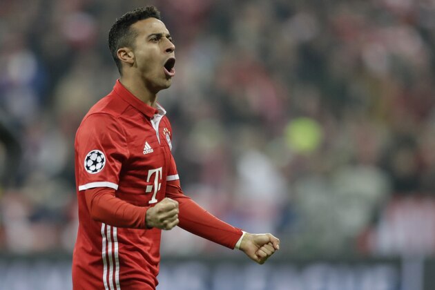 Bayern's Thiago Alcantara celebrates after his teammate Robert Lewandowski scored his side's second goal during the Champions League round of 16 first leg soccer match between FC Bayern Munich and Arsenal, in Munich, Germany, Wednesday, Feb. 15, 2017. (AP Photo/Matthias Schrader)