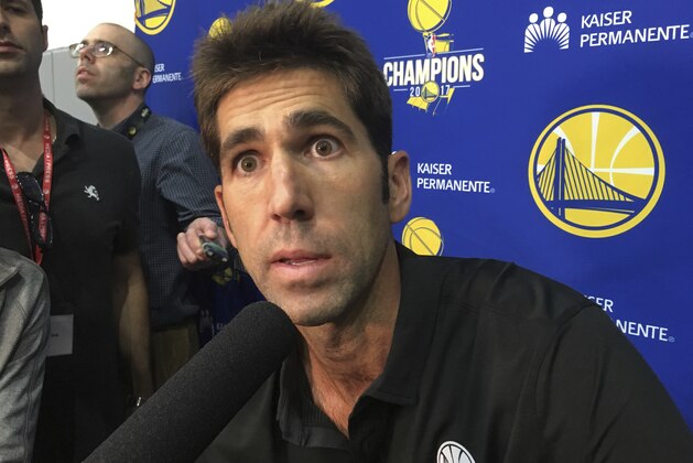 Golden State Warriors general manager Bob Myers takes questions from the media after NBA basketball practice in Oakland, Calif., Saturday, Sept. 23, 2017. President Donald Trump doubled down on denouncing protests by NFL players and rescinded NBA star Stephen Curry's White House invitation on Saturday, a series of tweets that quickly inflamed football and basketball stars and even prompted LeBron James to call the president a