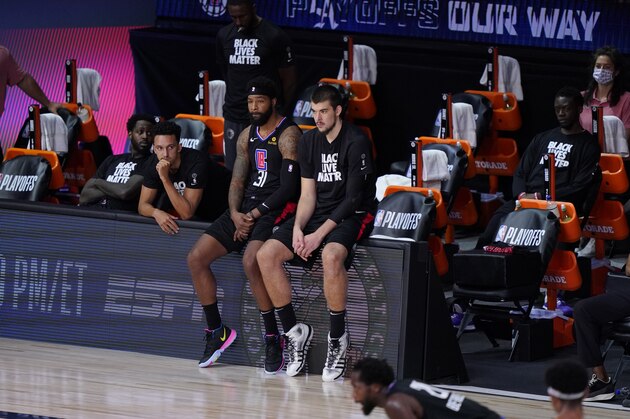 The Los Angeles Clippers players sit on the bench during the second half as they fall to the Denver Nuggets in an NBA conference semifinal playoff basketball game Tuesday, Sept. 15, 2020, in Lake Buena Vista, Fla. (AP Photo/Mark J. Terrill)
