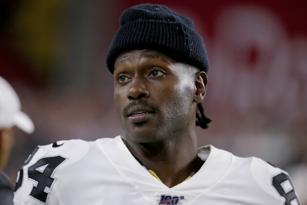 FILE - In this Aug. 15, 2019, file photo, Oakland Raiders wide receiver Antonio Brown watches from the sidelines during the second half of the team's NFL preseason football game against the Arizona Cardinals in Glendale, Ariz. Brown, who was released by the Raiders last week and is now with the New England Patriots, has been accused of rape by a former trainer. Britney Taylor says Brown sexually assaulted her on three occasions, according to a lawsuit filed Tuesday, Sept. 10, in the Southern District of Florida. Brown has denied the allegations (AP Photo/Rick Scuteri, File)