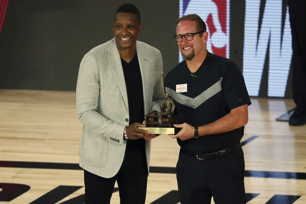 Toronto Raptors head coach Nick Nurse is presented his NBA coach of the year award by team president Masai Ujiri before of Game 4 of an NBA basketball first-round playoff series, Sunday, Aug. 23, 2020, in Lake Buena Vista, Fla. (Kim Klement/Pool Photo via AP)