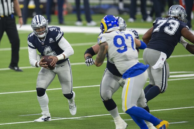 Dallas Cowboys quarterback Dak Prescott, left, sprints with the ball during an NFL football game against the Los Angeles Rams, Sunday, Sept. 13, 2020, in Inglewood, Calif. (AP Photo/Kyusung Gong)