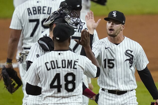 Chicago White Sox's Adam Engel (15) celebrates with catcher Yasmani Grandal and relief pitcher Alex Colome the team's 3-1 win over the Minnesota Twins after a baseball game, Monday, Sept. 14, 2020, in Chicago. (AP Photo/Charles Rex Arbogast)