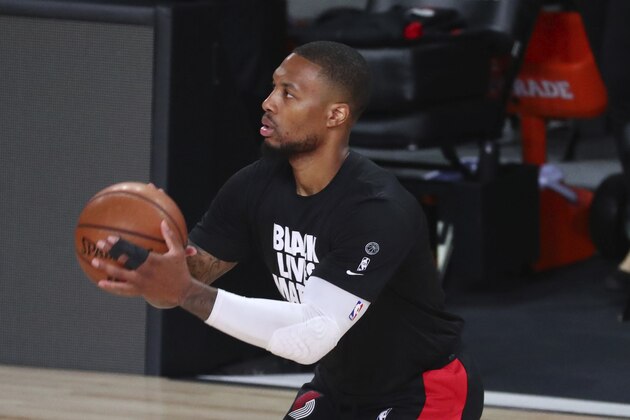 Portland Trail Blazers guard Damian Lillard warms up for Game 3 of the team's NBA basketball first-round playoff series against the Los Angeles Lakers, Saturday, Aug. 22, 2020, in Lake Buena Vista, Fla. (Kim Klement/Pool Photo via AP)